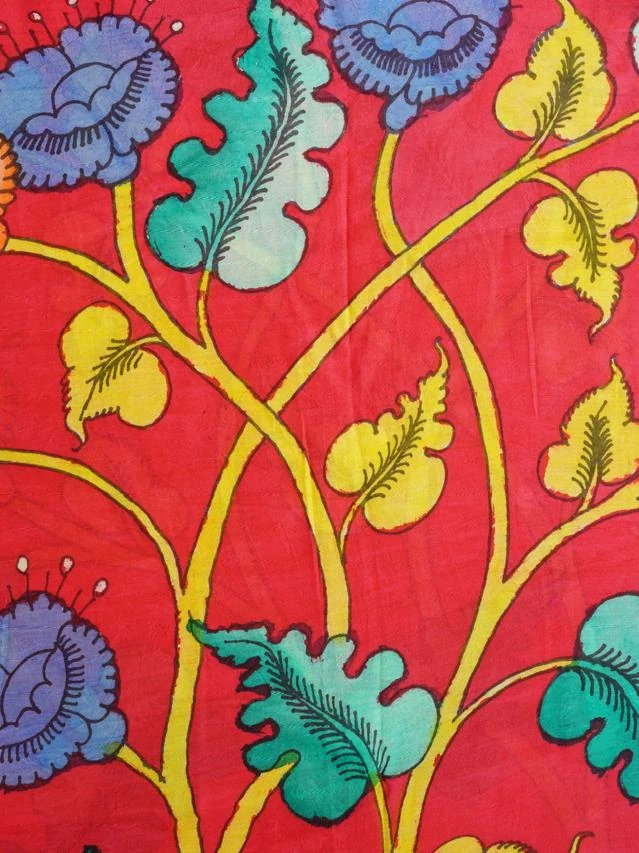 Hand-painted cotton: a yellow vine carrying leaves and flowers in blue, green and orange across a deep red ground
